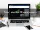 Person managing personal finances on laptop with budgeting charts and financial planning tools on desk